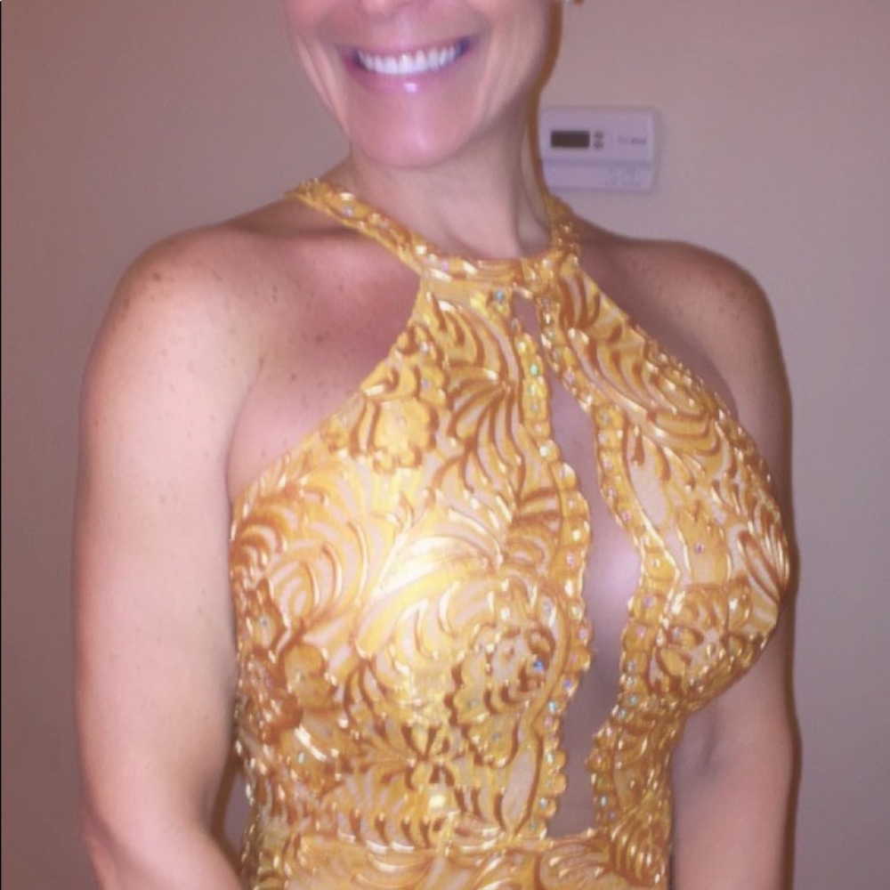 This is a couture hand painted dress with crystals. This dress is a must have.